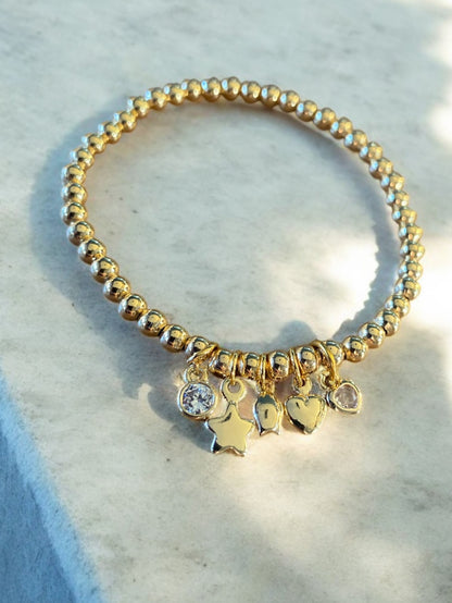 Pulsera con mini dijes - baño en oro