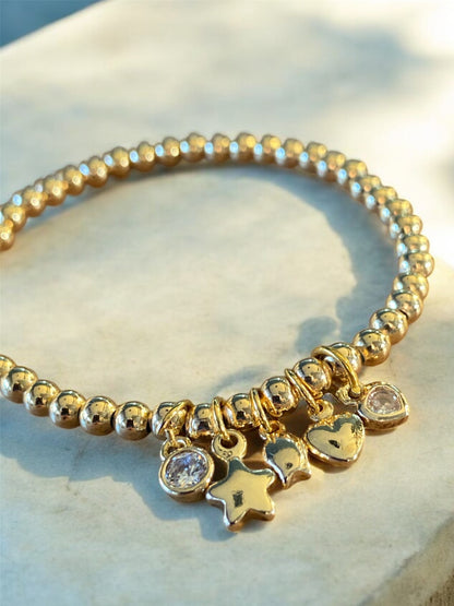 Pulsera con mini dijes - baño en oro