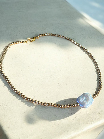 Collar dorado con perla barroca